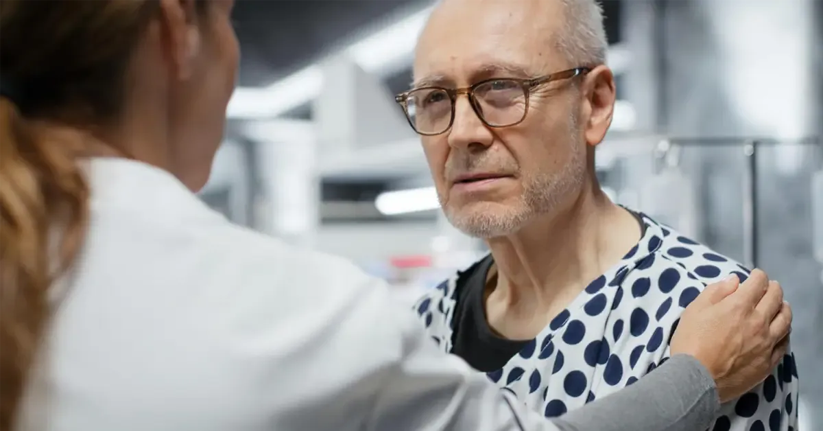 Physiotherapist providing supportive care and consultation to a senior patient with shoulder injury or proximal humerus fracture